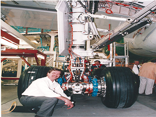 Team member inspecting aircraft landing gear on the assembly floor
