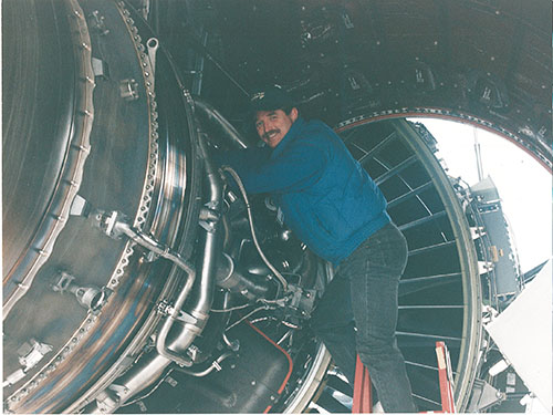 Technician working inside an aircraft engine nacelle